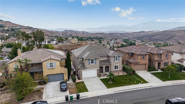 16219 Skyridge Dr, Riverside, CA 92503 - view of front facade featuring a residential view, stucco siding, concrete driveway, an attached garage, and a mountain view