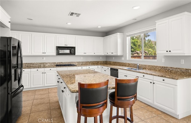 16219 Skyridge Dr, Riverside, CA 92503 - kitchen with black appliances, a sink, a kitchen island, white cabinetry, and recessed lighting