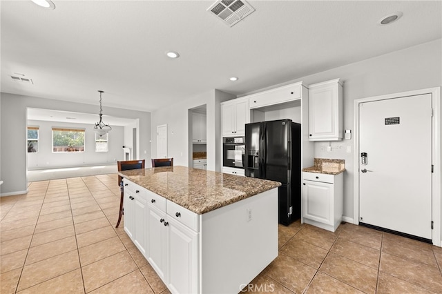 16219 Skyridge Dr, Riverside, CA 92503 - kitchen with black appliances, light tile patterned floors, a kitchen island, white cabinets, and stone countertops