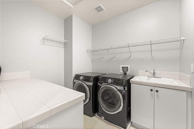 16219 Skyridge Dr, Riverside, CA 92503 - laundry area featuring washer and clothes dryer and cabinet space