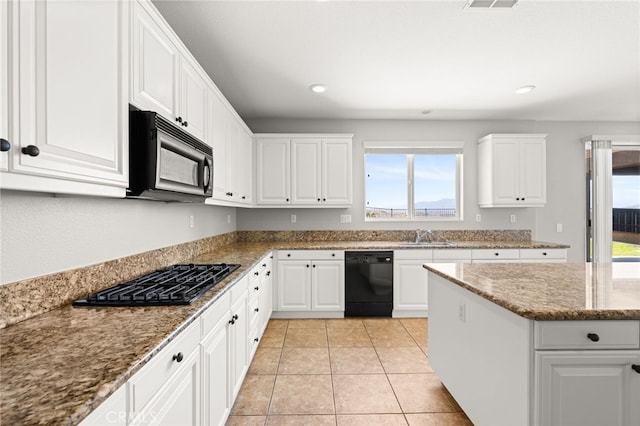 16219 Skyridge Dr, Riverside, CA 92503 - kitchen with black appliances, healthy amount of natural light, white cabinets, recessed lighting, and stone counters