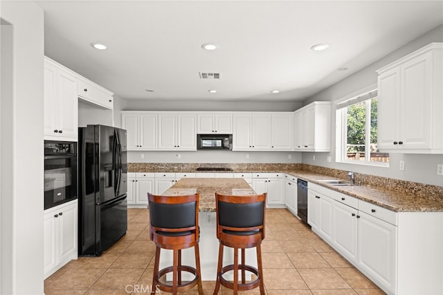 16219 Skyridge Dr, Riverside, CA 92503 - kitchen with black appliances, a kitchen island, white cabinets, and recessed lighting