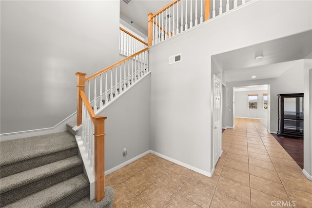 16219 Skyridge Dr, Riverside, CA 92503 - stairs featuring tile patterned flooring, baseboards, and a towering ceiling