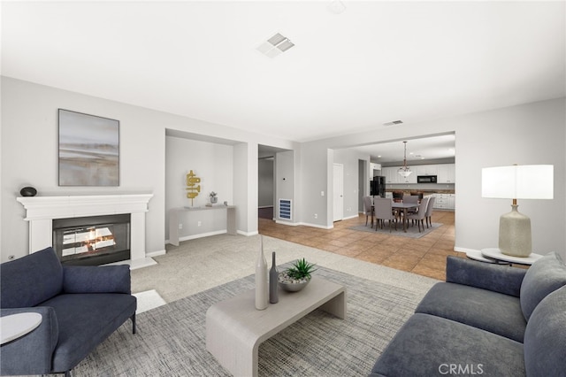 16219 Skyridge Dr, Riverside, CA 92503 - living area with a glass covered fireplace, baseboards, and light tile patterned floors