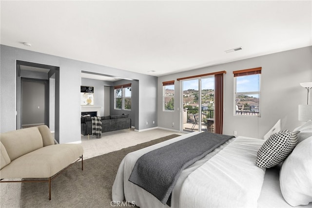 16219 Skyridge Dr, Riverside, CA 92503 - bedroom with access to exterior, carpet floors, a fireplace, and baseboards