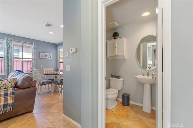 bathroom featuring toilet, tile patterned flooring, a sink, and visible vents