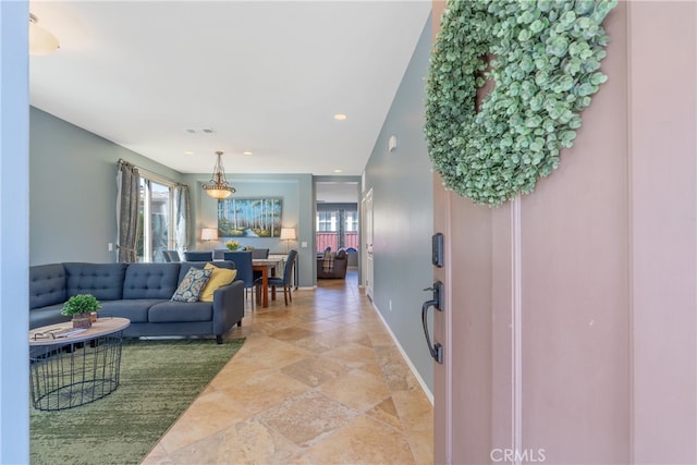 living room with recessed lighting, a wealth of natural light, baseboards, and visible vents