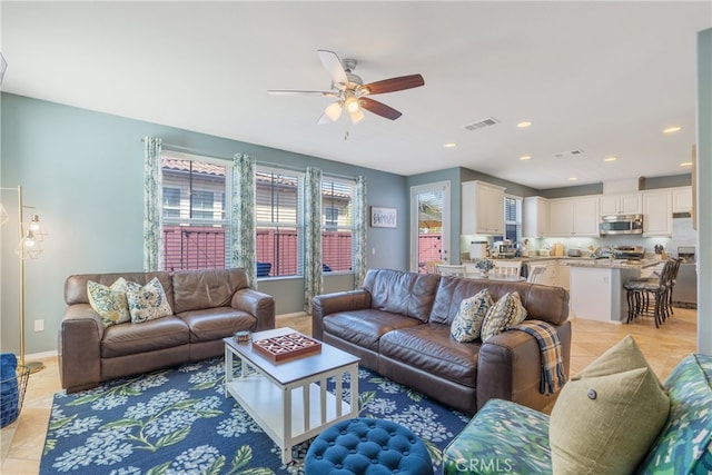 living room featuring ceiling fan, baseboards, visible vents, and recessed lighting