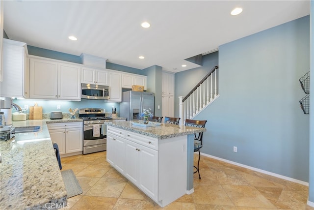 kitchen featuring white cabinetry, stainless steel appliances, and a sink