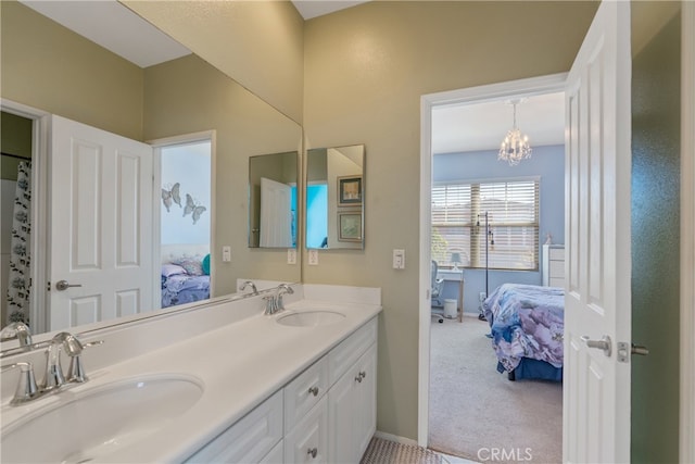 full bathroom with a sink, connected bathroom, a chandelier, and double vanity
