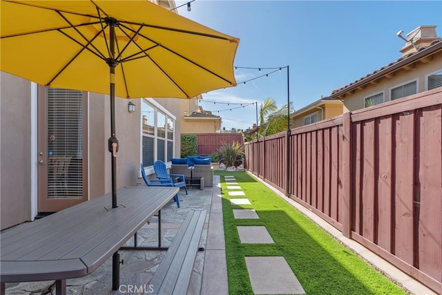 view of yard featuring an outdoor hangout area, a patio area, and a fenced backyard