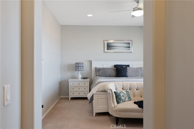 carpeted bedroom featuring baseboards and ceiling fan