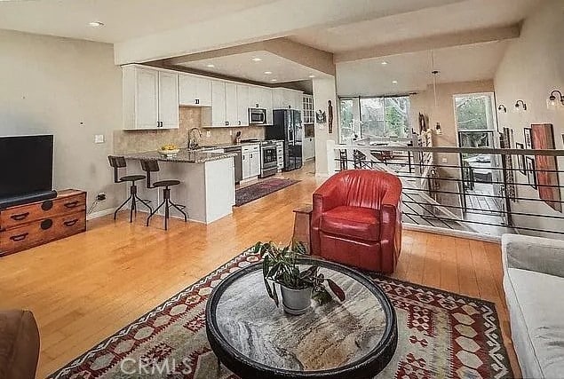 living room with light wood-style floors and baseboards