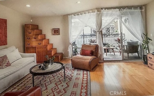 living area with stairway, recessed lighting, and light wood finished floors