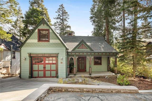 229 Maple Dr, Lake Arrowhead, CA 92352 - victorian-style house featuring a porch, driveway, roof with shingles, and a chimney