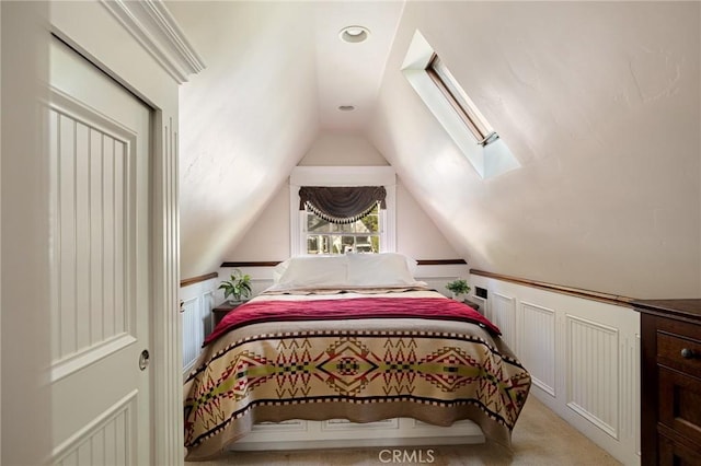 229 Maple Dr, Lake Arrowhead, CA 92352 - bedroom with a skylight, lofted ceiling, a decorative wall, wainscoting, and light colored carpet