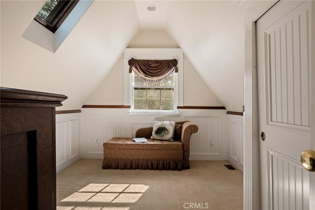 229 Maple Dr, Lake Arrowhead, CA 92352 - sitting room featuring a wainscoted wall, a decorative wall, lofted ceiling, carpet, and a skylight