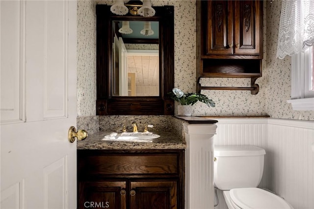 229 Maple Dr, Lake Arrowhead, CA 92352 - bathroom with wallpapered walls, vanity, toilet, and wainscoting