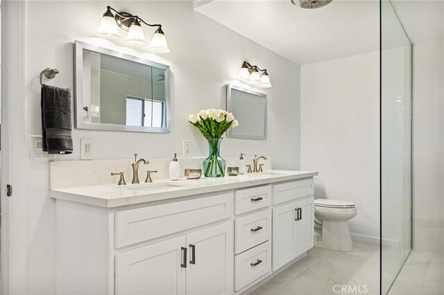 28919 Palisades Dr, Lake Arrowhead, CA 92352 - bathroom featuring double vanity, marble finish floor, a sink, and toilet