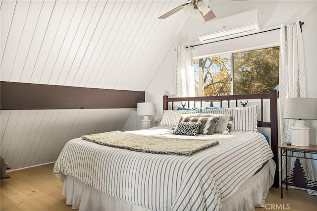 28919 Palisades Dr, Lake Arrowhead, CA 92352 - bedroom with lofted ceiling, ceiling fan, a wall unit AC, and wood finished floors
