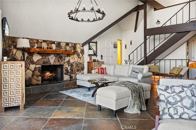 28919 Palisades Dr, Lake Arrowhead, CA 92352 - living area featuring a notable chandelier, a stone fireplace, wood ceiling, stairs, and stone tile floors