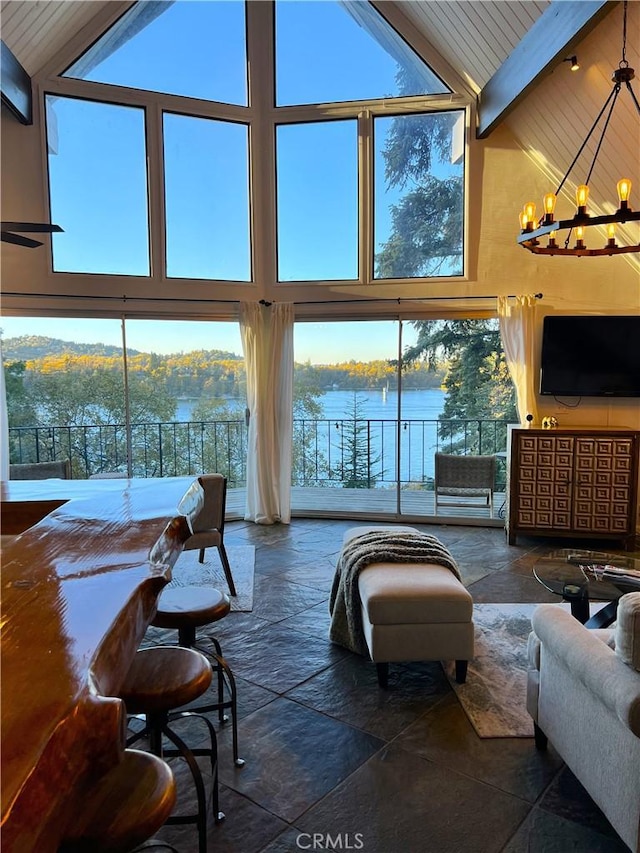 28919 Palisades Dr, Lake Arrowhead, CA 92352 - living area with an inviting chandelier, stone tile floors, wooden ceiling, a healthy amount of sunlight, and beam ceiling