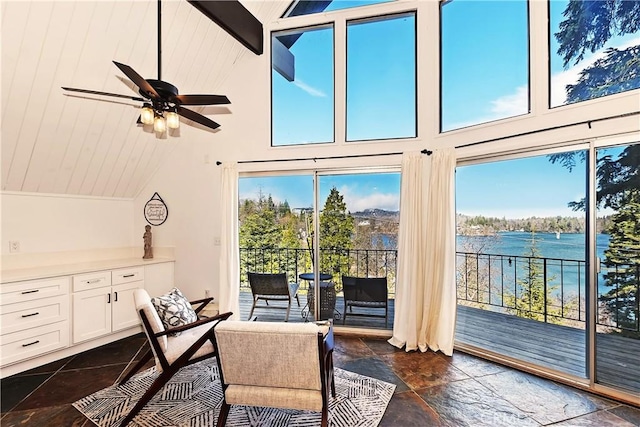 28919 Palisades Dr, Lake Arrowhead, CA 92352 - interior space featuring a water view, stone tile flooring, ceiling fan, and vaulted ceiling with beams