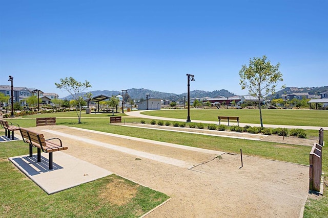 view of property's community featuring a mountain view, a residential view, and a yard