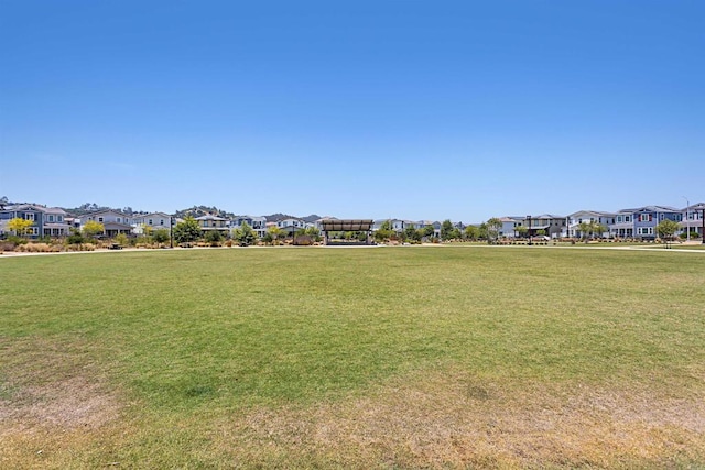 view of property's community featuring a residential view and a yard