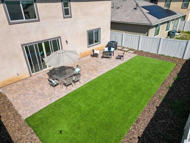 view of yard with fence, a patio area, and central AC