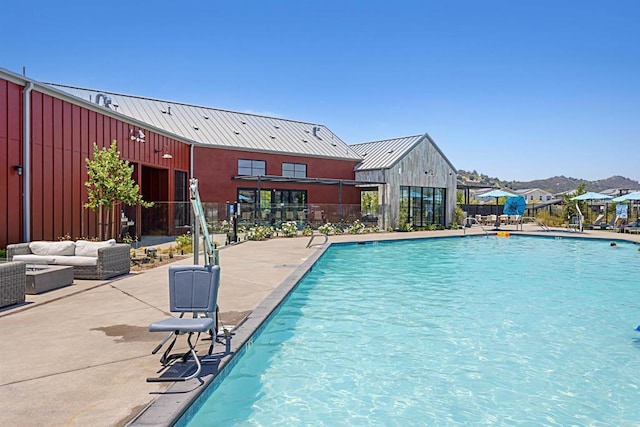 pool featuring fence, a patio area, and outdoor lounge area