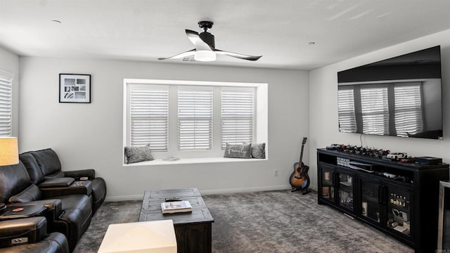 carpeted living area featuring a healthy amount of sunlight, ceiling fan, and baseboards