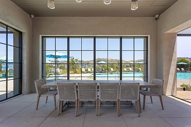 exterior space with outdoor dining area and a community pool