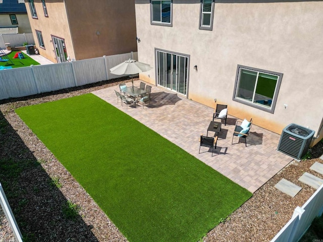 view of yard featuring cooling unit, a patio, and a fenced backyard