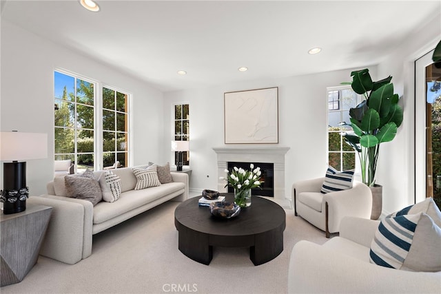 living room featuring recessed lighting and a glass covered fireplace