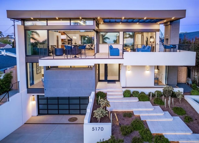 5170 Carlsbad Blvd, Carlsbad, CA 92008 - modern home featuring a balcony, concrete driveway, stucco siding, and a garage