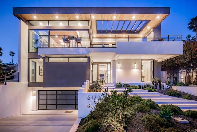 5170 Carlsbad Blvd, Carlsbad, CA 92008 - modern home featuring a balcony, stucco siding, and concrete driveway