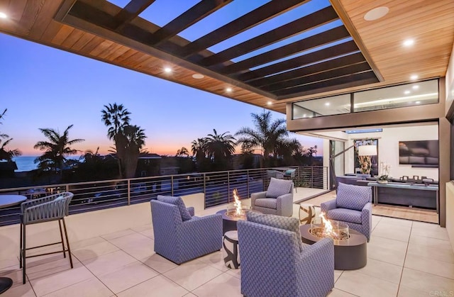 5170 Carlsbad Blvd, Carlsbad, CA 92008 - patio terrace at dusk with an outdoor living space with a fire pit and a pergola