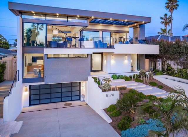 5170 Carlsbad Blvd, Carlsbad, CA 92008 - contemporary house with a balcony, an attached garage, driveway, and stucco siding