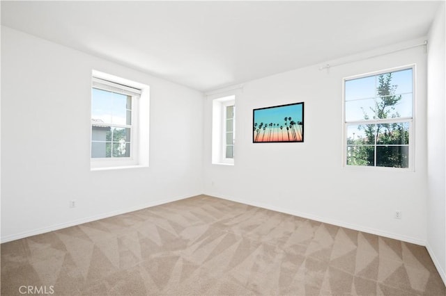 empty room with baseboards and carpet