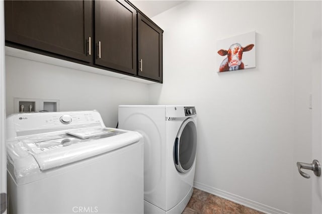 laundry area with washer and dryer, baseboards, and cabinet space