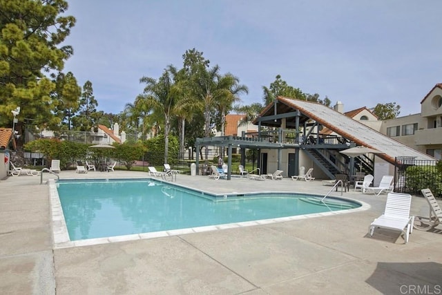 pool featuring a patio area and fence