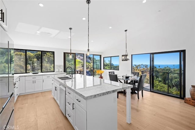 990 Meadowlark Dr, Laguna Beach, CA 92651 - kitchen with white cabinets, light stone countertops, light wood finished floors, and a sink