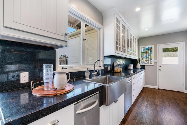 kitchen with a sink, backsplash, white cabinets, and dark wood-style floors