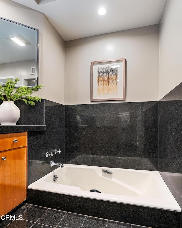 full bathroom with a tub to relax in, granite finish floor, and recessed lighting