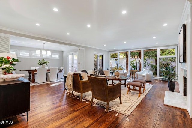 living area with a healthy amount of sunlight, recessed lighting, ornamental molding, and dark wood finished floors