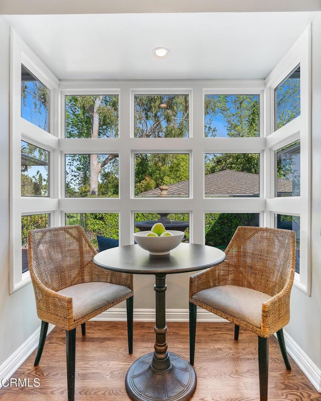 sunroom / solarium with wood finished floors, baseboards, and recessed lighting