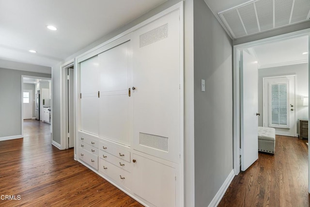 hallway featuring recessed lighting, visible vents, baseboards, and dark wood finished floors