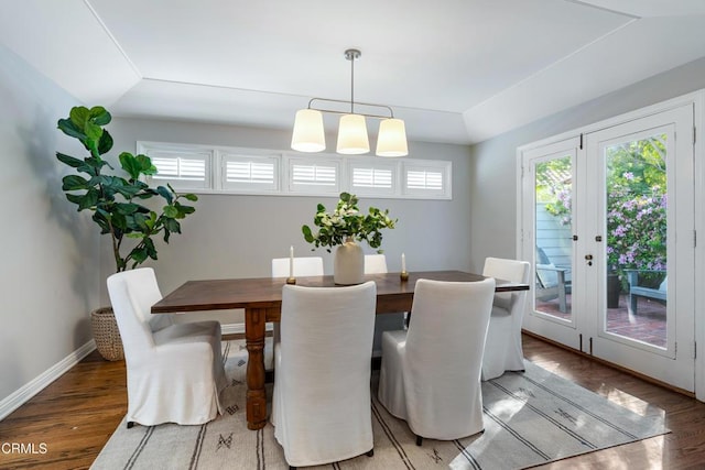 dining space featuring baseboards and wood finished floors