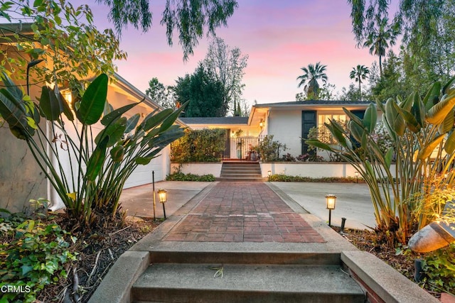 view of front of home featuring concrete driveway, stucco siding, and a garage